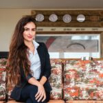 a woman sitting on a couch in a room